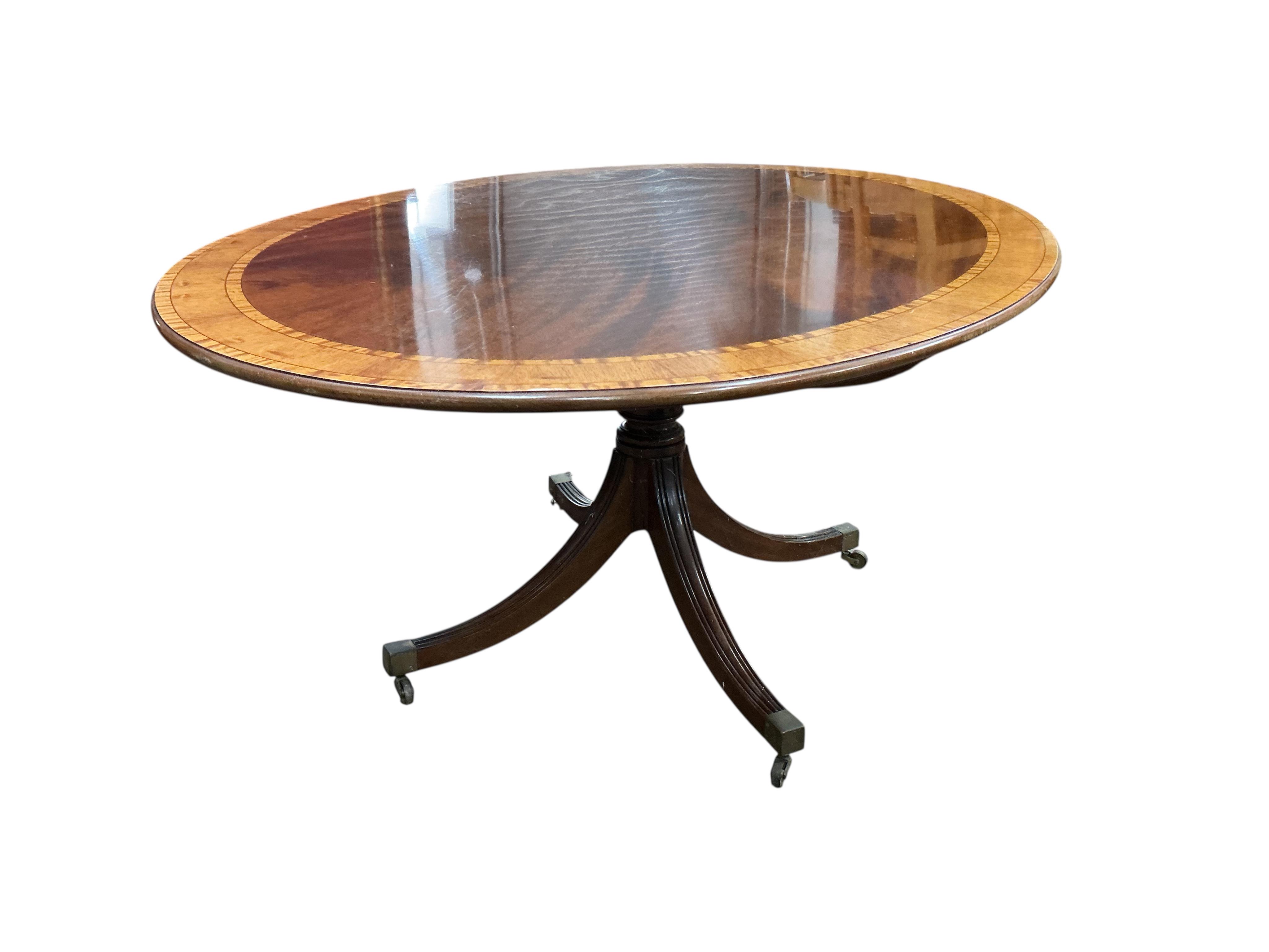 A reproduction William Tillman George III style oval banded mahogany dining table (lacks bolts), width 168cm, depth 120cm, height 72cm